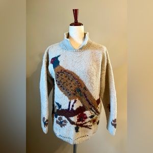 100% Wool pullover sweater with high neck and knitted bird detail in front